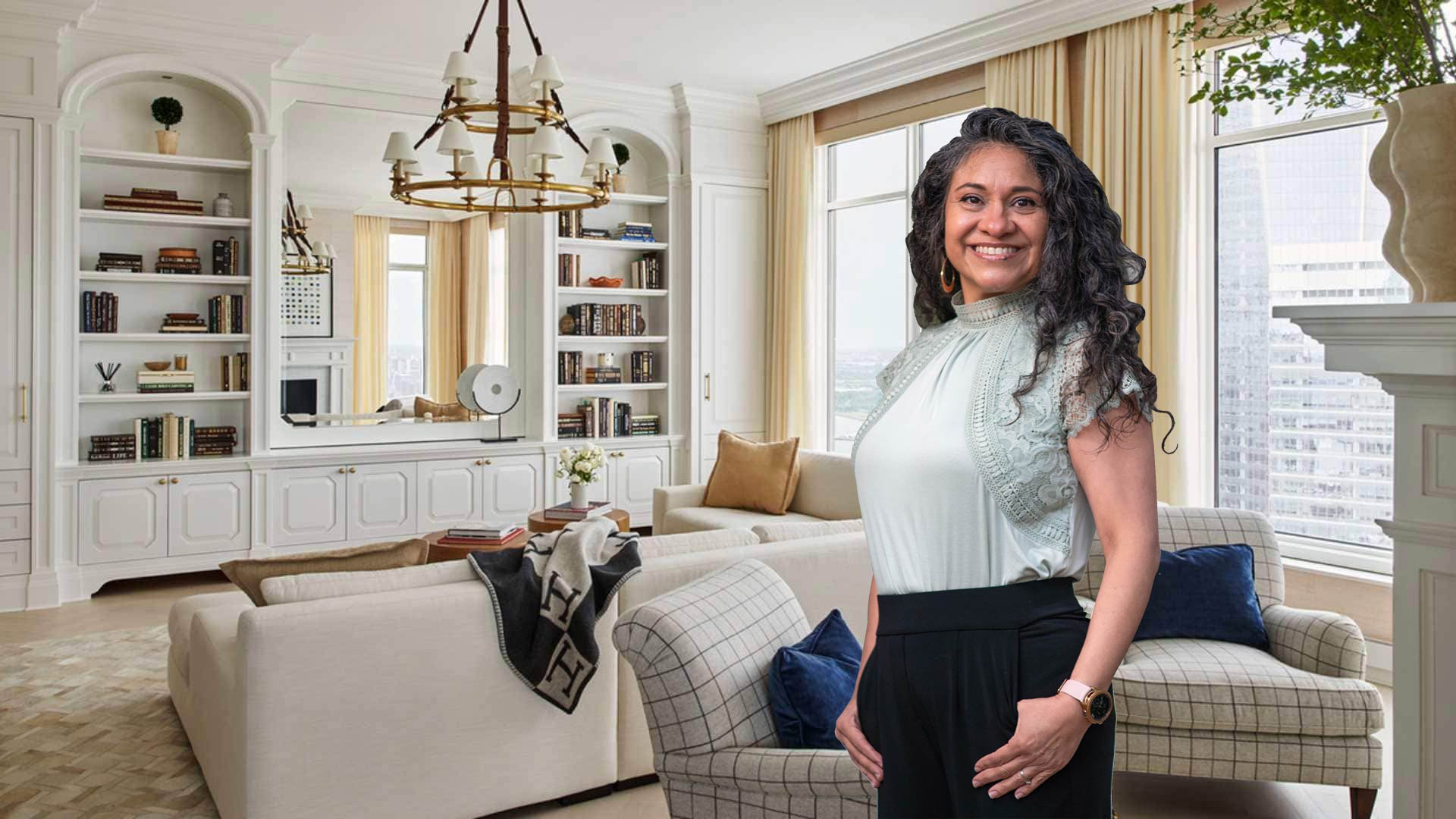 Photo of Sonia standing in a beautiful, light color living room.